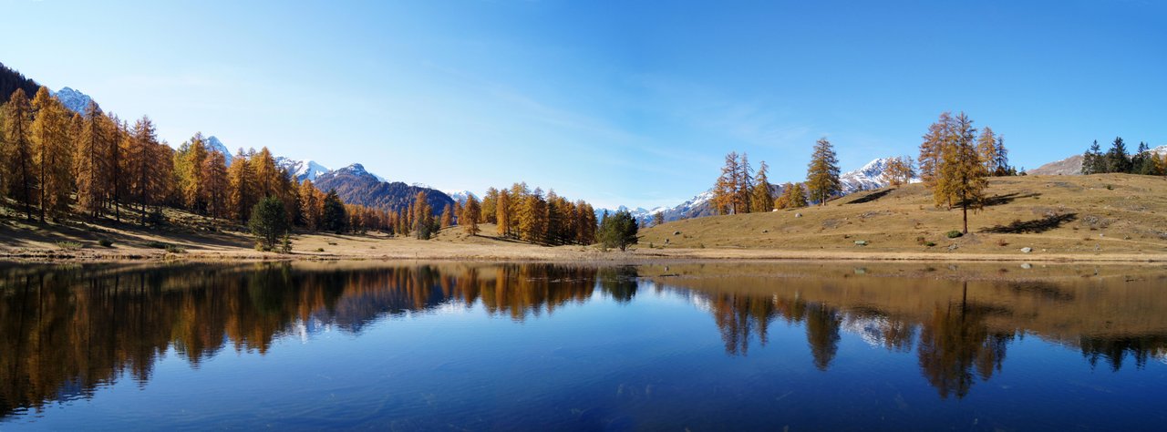 Lai Nair reflecting autumn trees and the surrounding mountains.